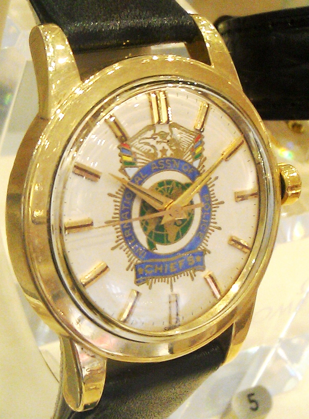 E34 Case 92 Official Secret society Interpol Chief gold Seamaster watch.jpg